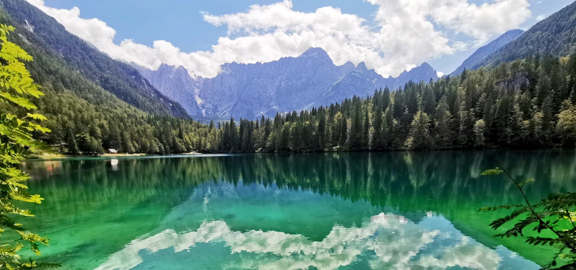 Mountain lake surrounded by forest and peaks