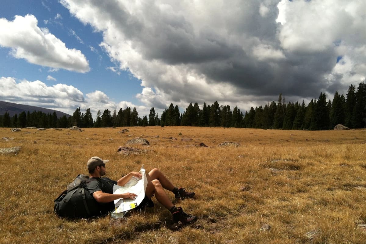 Hiker checking a map on the trail